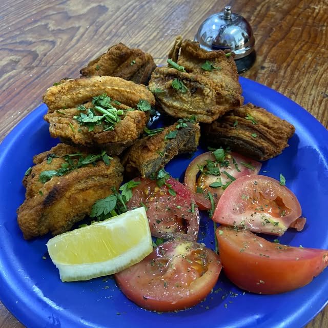 Pescado frito con tomate y limón